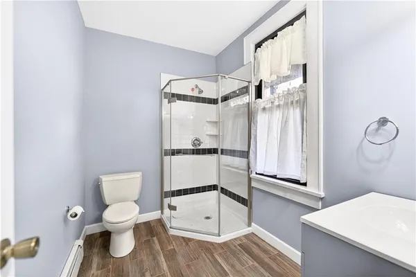 a bathroom with a toilet a sink and a mirror