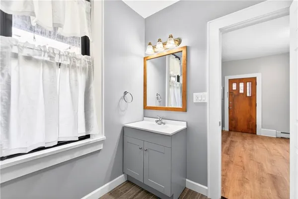 a bathroom with a sink a mirror and a window