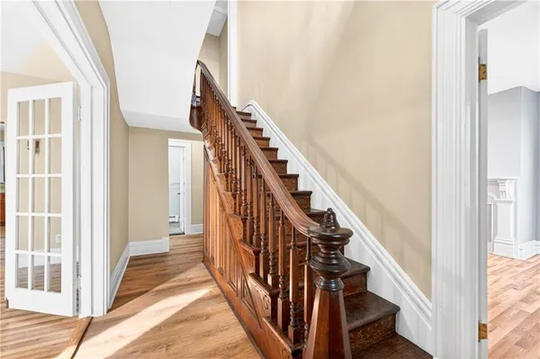 a view of an entryway with wooden floor