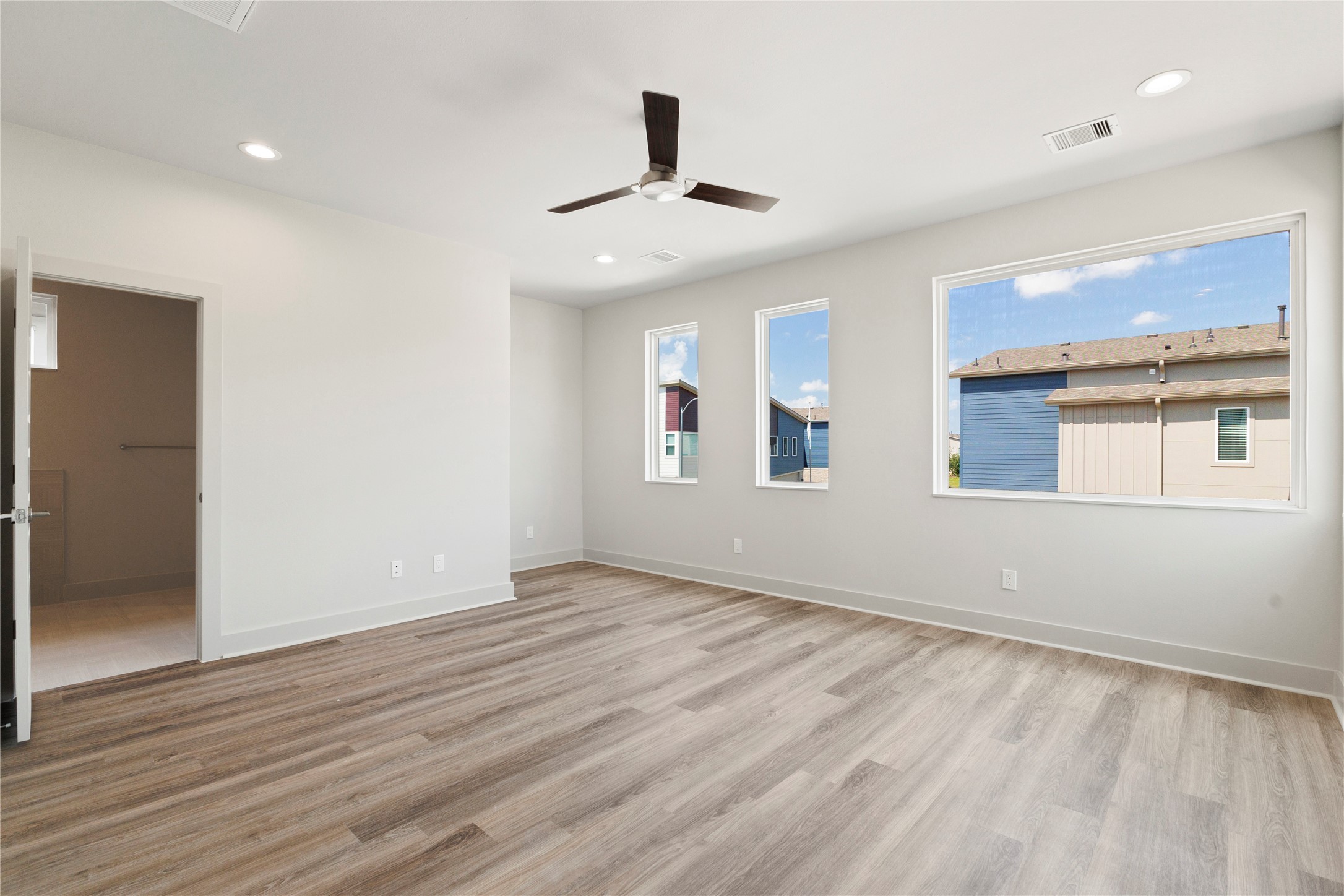 5726 Rucio Lane Houston, TX 77092 - Photo 14 of 30 an empty room with wooden floor chandelier fan and windows