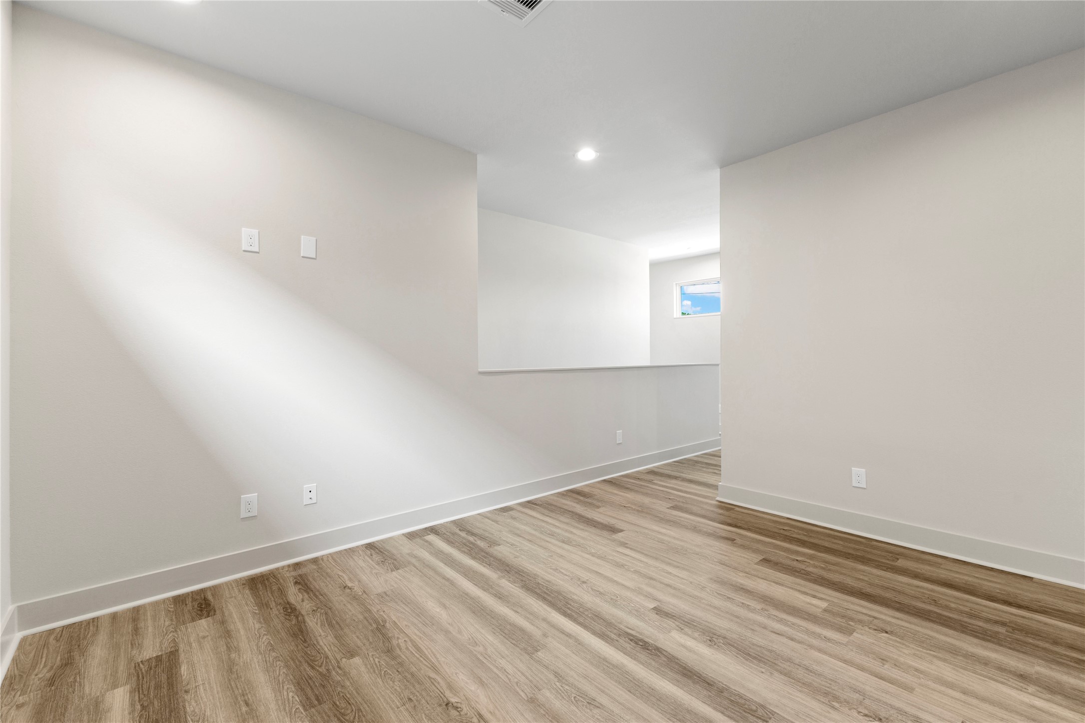 5726 Rucio Lane Houston, TX 77092 - Photo 18 of 30 an empty room with wooden floor and windows