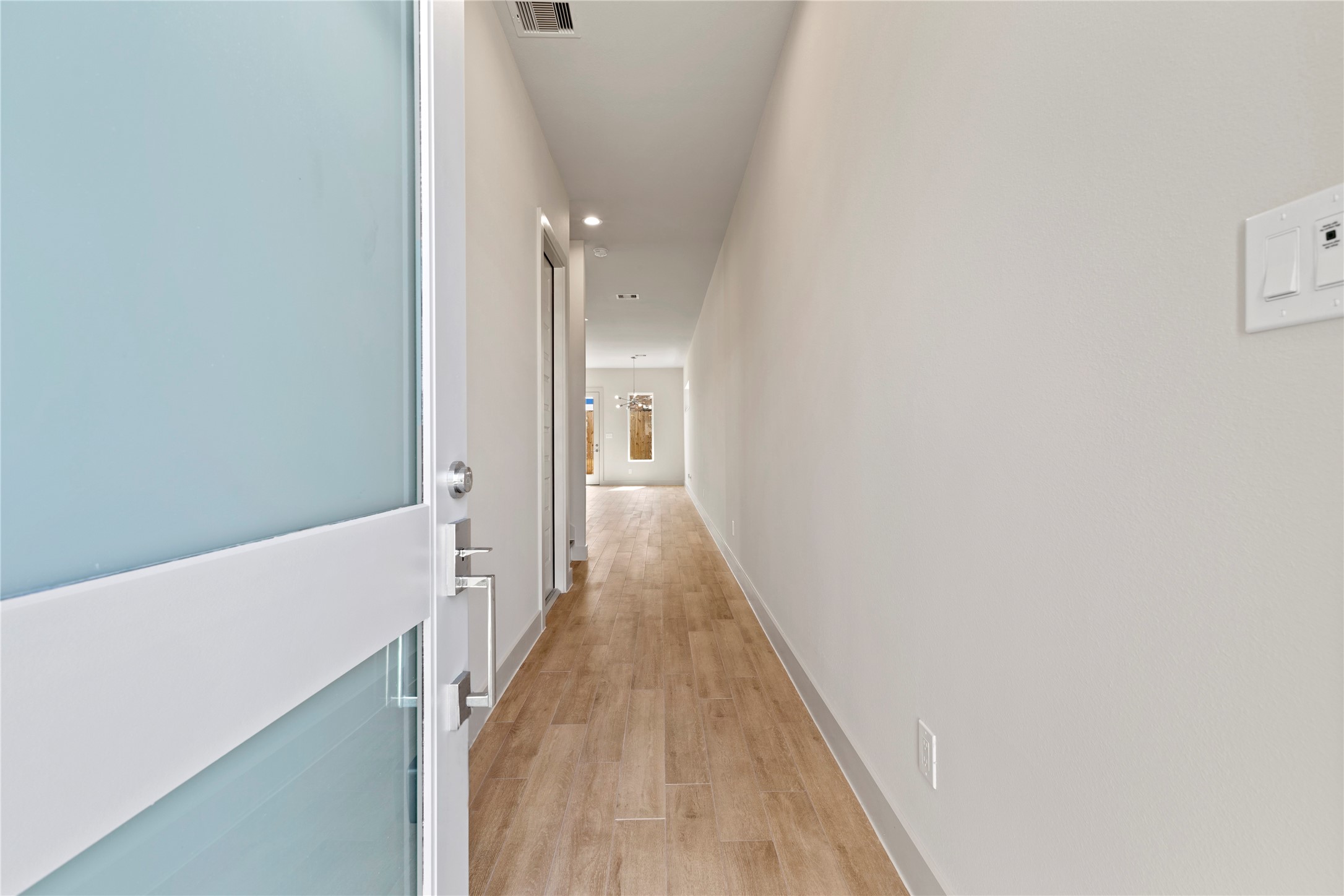 5726 Rucio Lane Houston, TX 77092 - Photo 4 of 30 a view of a hallway with wooden floor