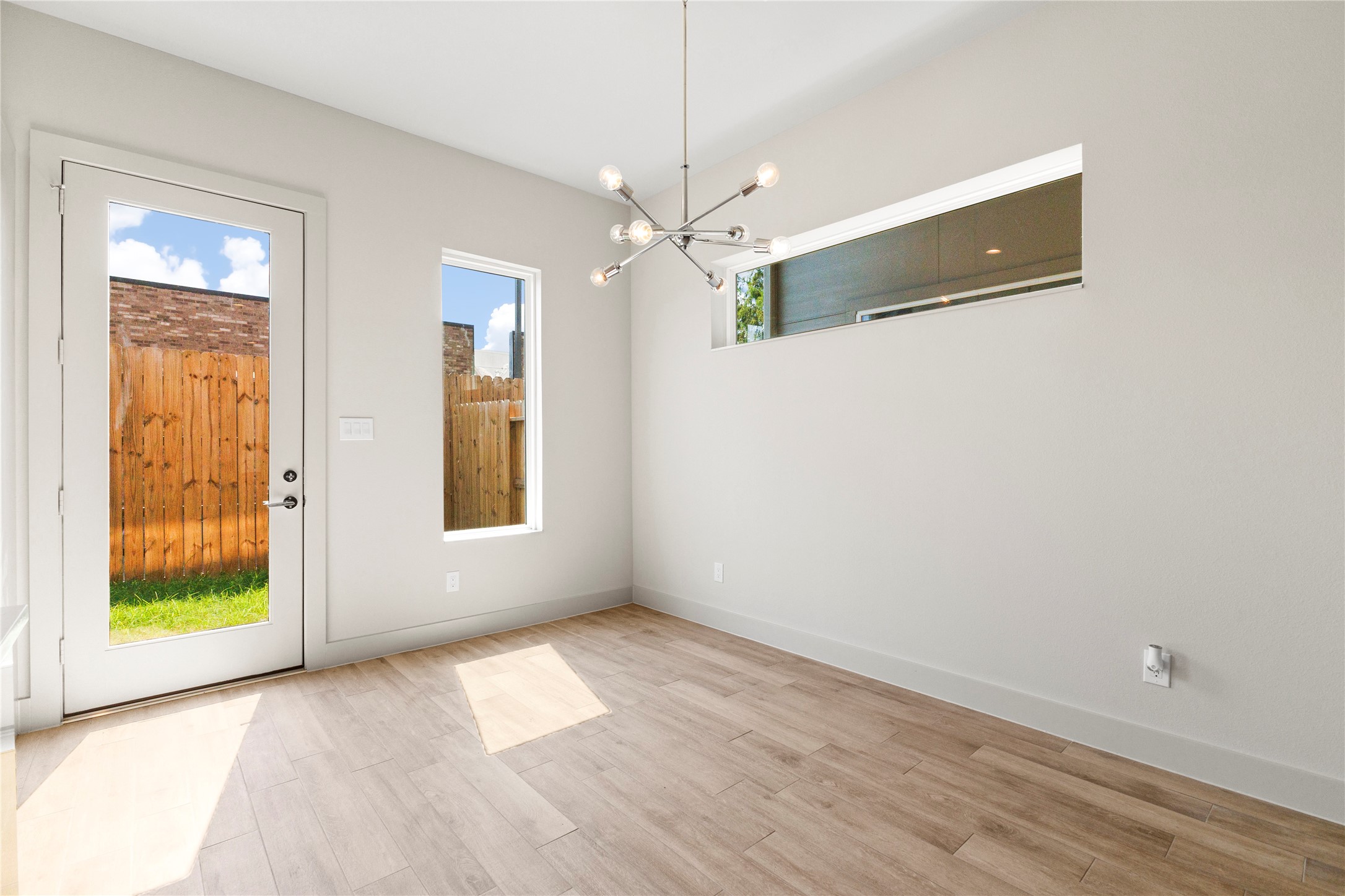 5726 Rucio Lane Houston, TX 77092 - Photo 8 of 30 a view of an empty room with window and chandelier