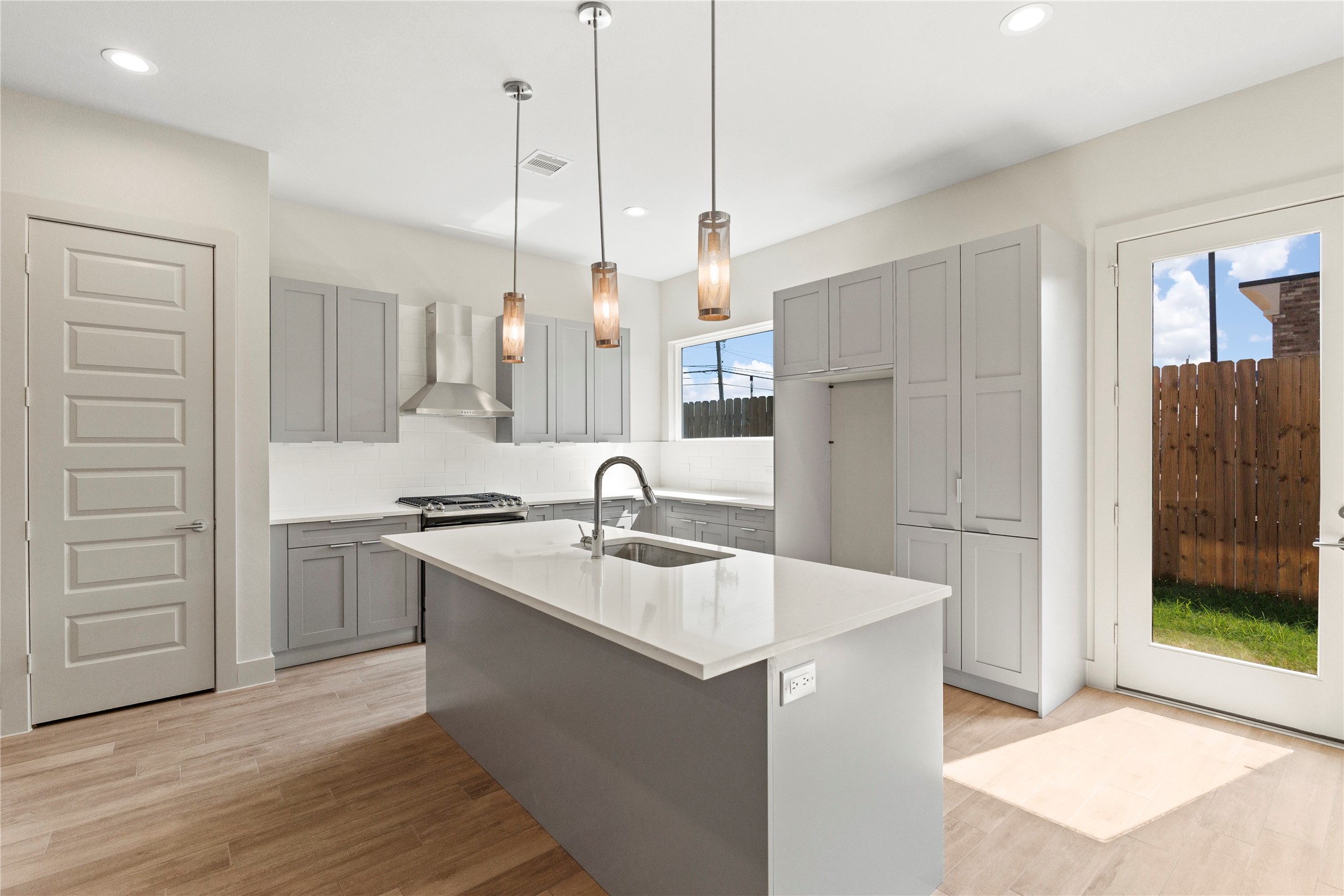 5726 Rucio Lane Houston, TX 77092 - Photo 9 of 30 a kitchen with a sink a stove a refrigerator and a oven