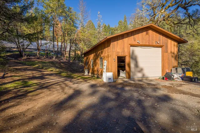 a bedroom with a bed and large windows