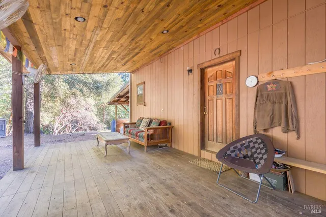 a bedroom with a bed and large windows