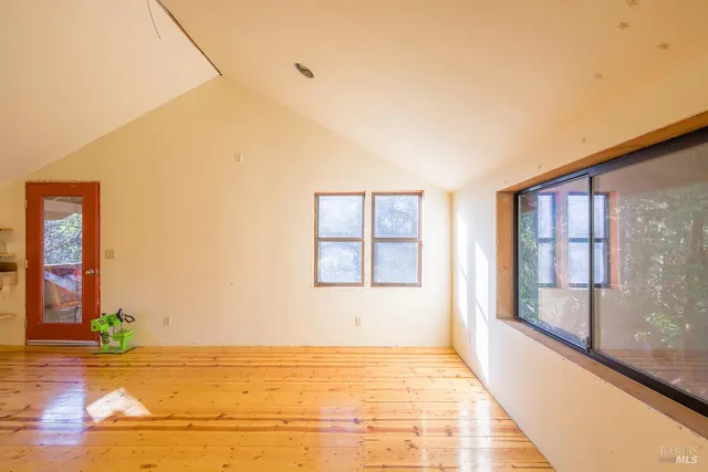 a view of a living room with a dining table and chairs