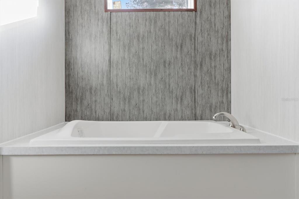 6919 South Sorrell Avenue Homosassa, FL 34446 - Photo 18 of 30 a bathroom with a bath tub