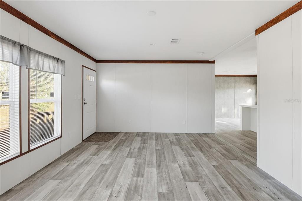 6919 South Sorrell Avenue Homosassa, FL 34446 - Photo 5 of 30 a view of empty room with wooden floor and fan