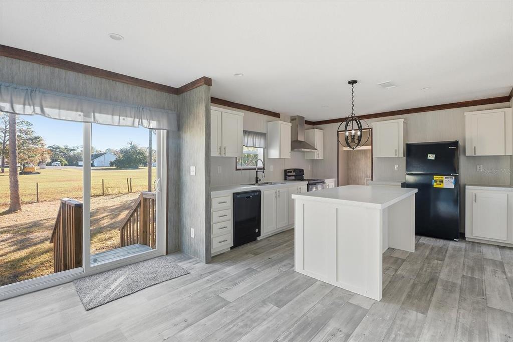 6919 South Sorrell Avenue Homosassa, FL 34446 - Photo 7 of 30 a kitchen with cabinets and refrigerator