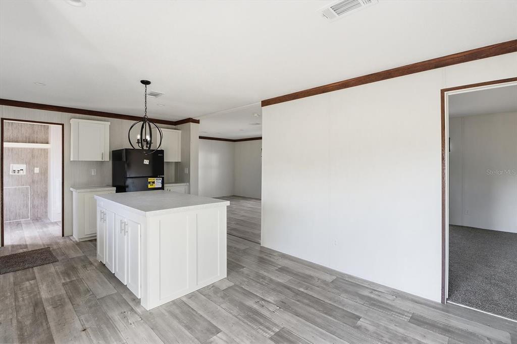 6919 South Sorrell Avenue Homosassa, FL 34446 - Photo 8 of 30 a kitchen with a refrigerator a sink and wooden floor