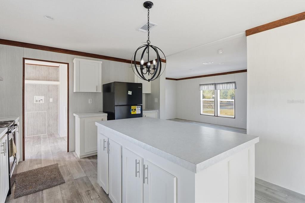 6919 South Sorrell Avenue Homosassa, FL 34446 - Photo 9 of 30 a view of a kitchen cabinets and a refrigerator