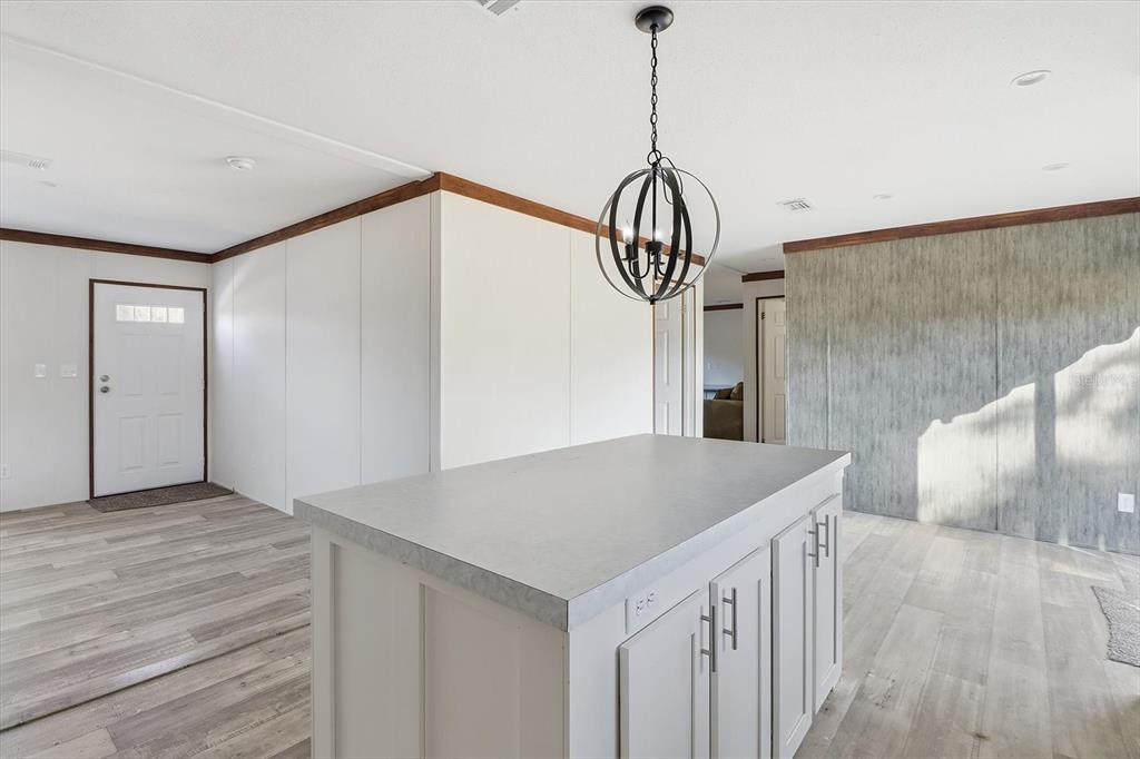 6919 South Sorrell Avenue Homosassa, FL 34446 - Photo 10 of 30 a view of a hallway to a room with wooden floor and windows