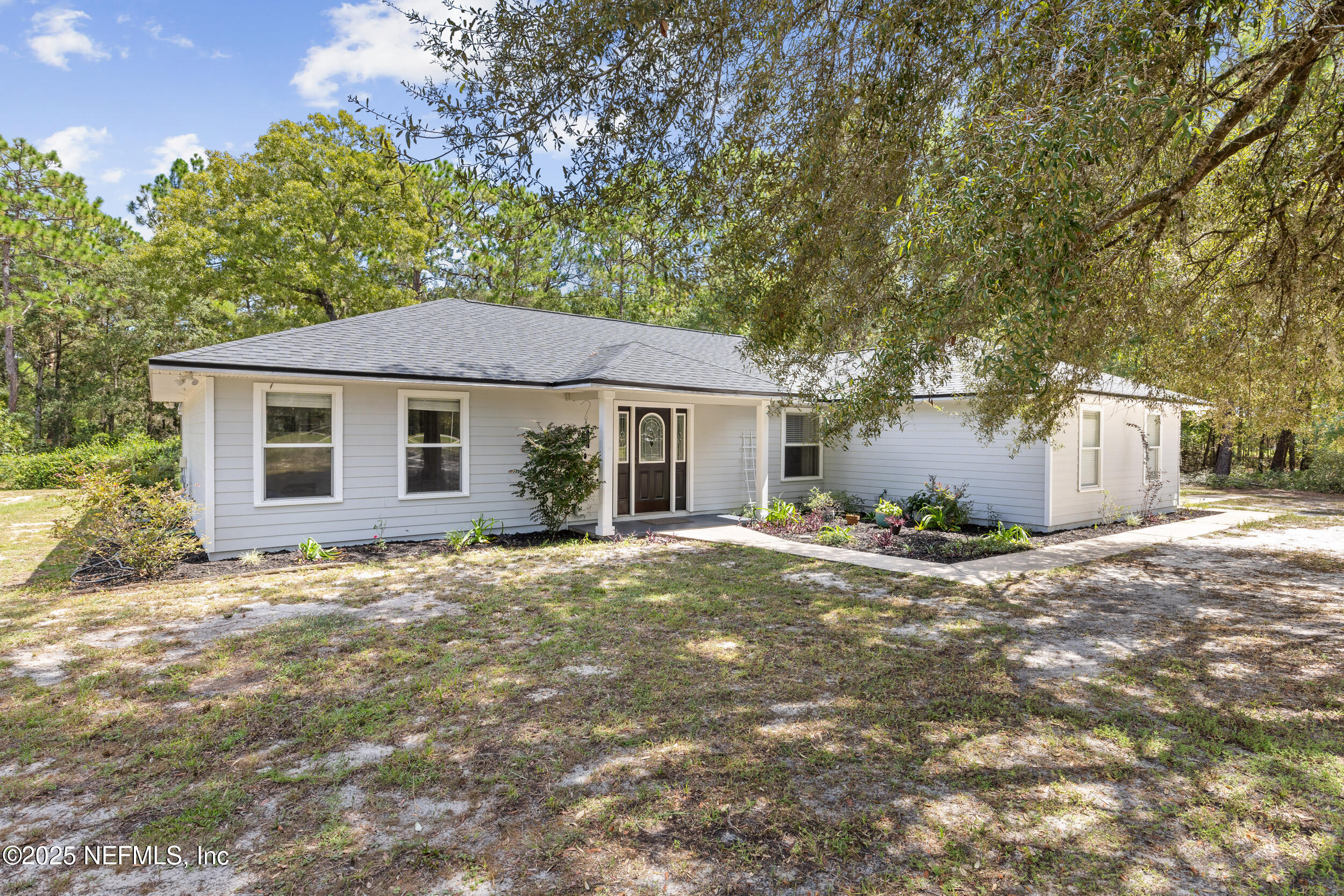 a front view of a house with a garden