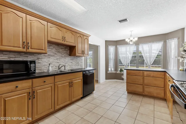 a kitchen with stainless steel appliances granite countertop a sink and cabinets