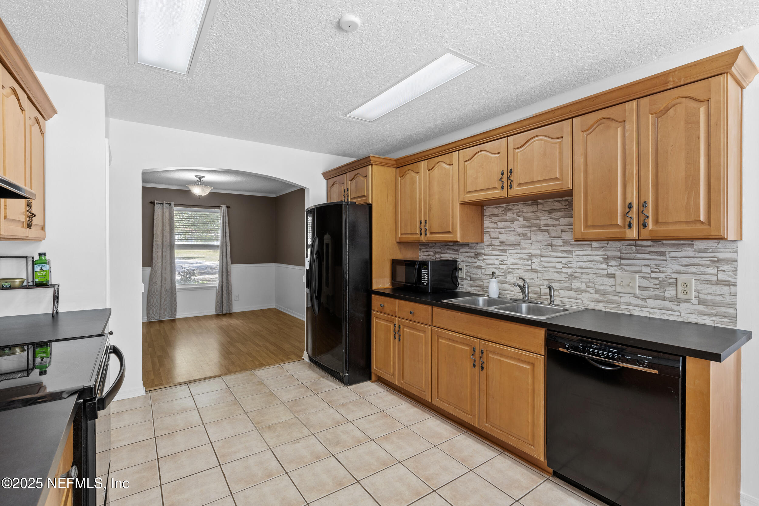 7557 Alameda Way Keystone Heights, FL 32656 - Photo 13 of 40 a kitchen with stainless steel appliances granite countertop a refrigerator a stove and a sink