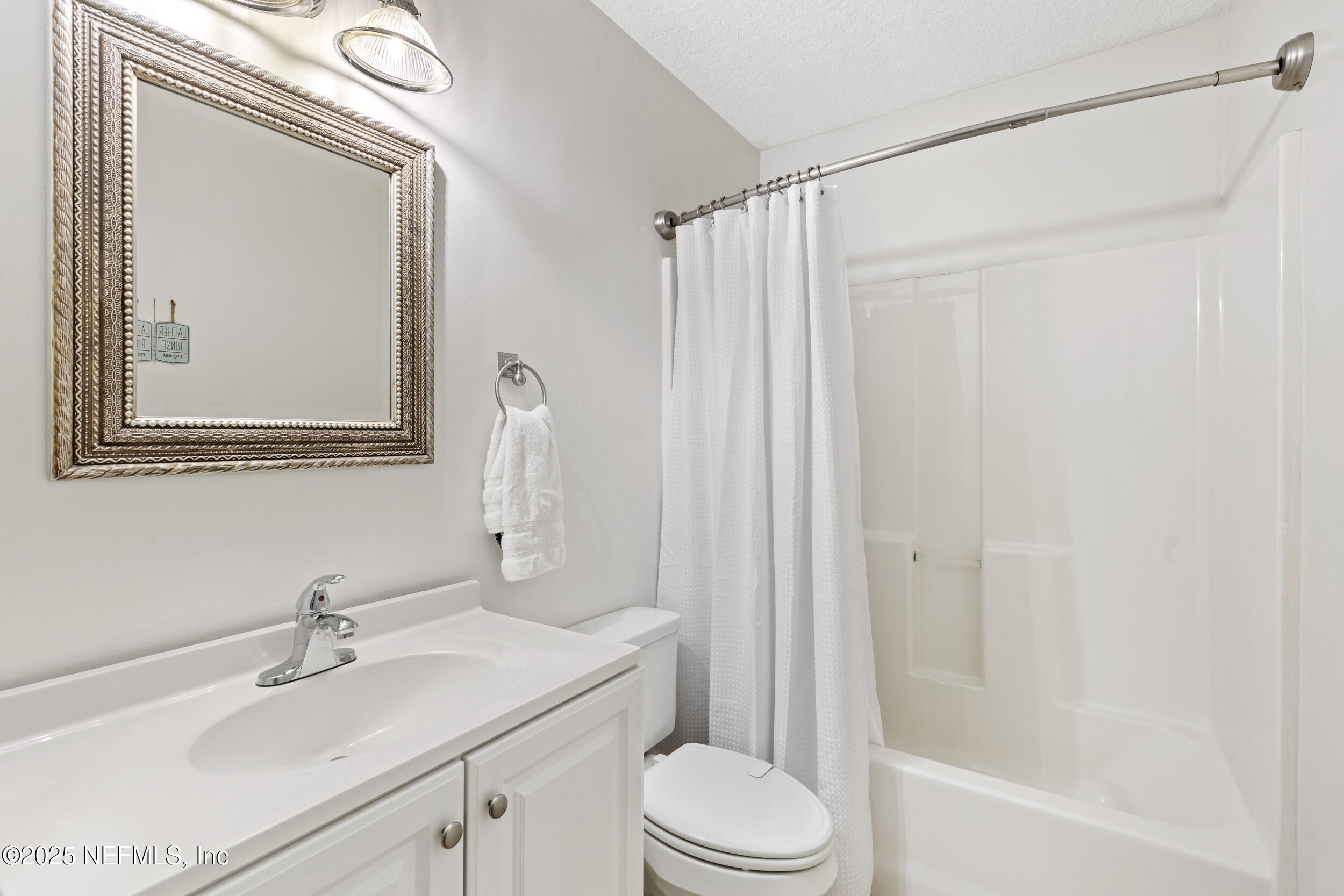 7557 Alameda Way Keystone Heights, FL 32656 - Photo 16 of 40 a bathroom with a sink a toilet and shower
