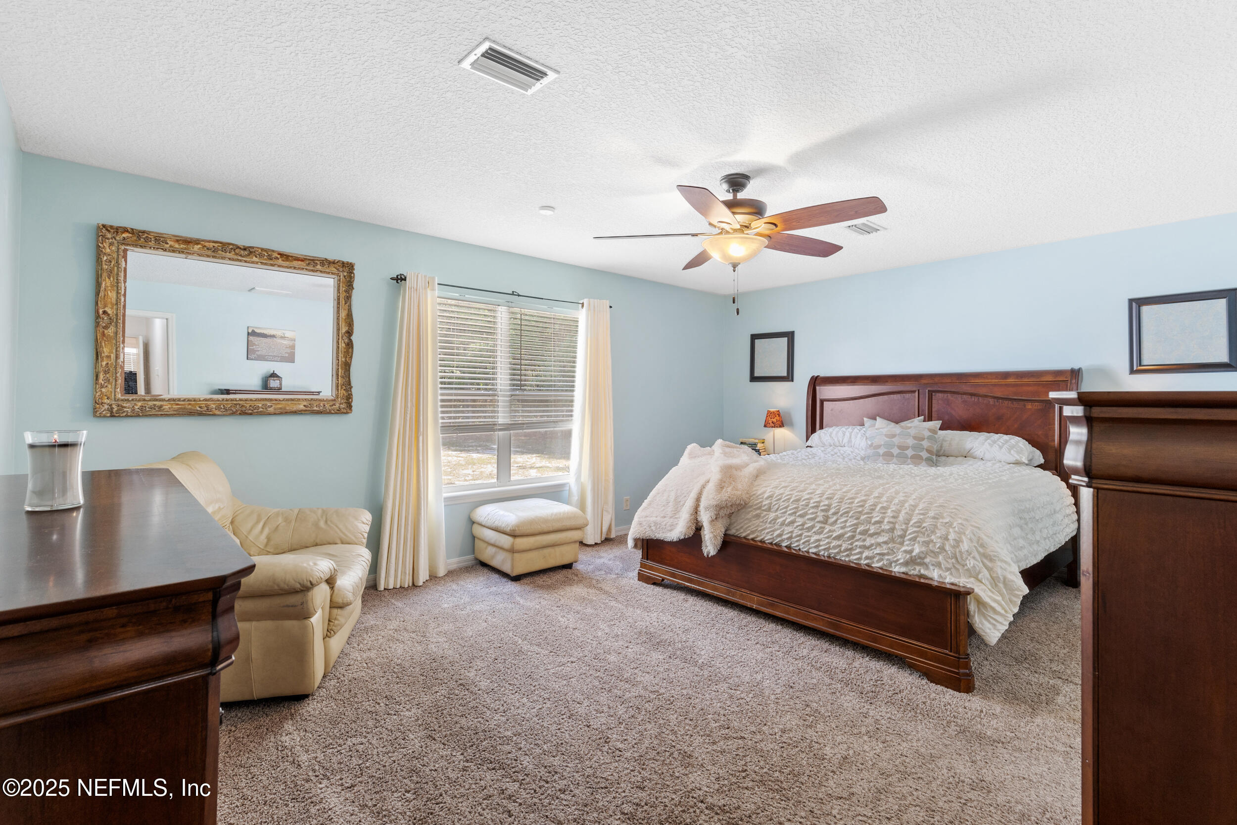 7557 Alameda Way Keystone Heights, FL 32656 - Photo 18 of 40 a bedroom with a bed and a couch
