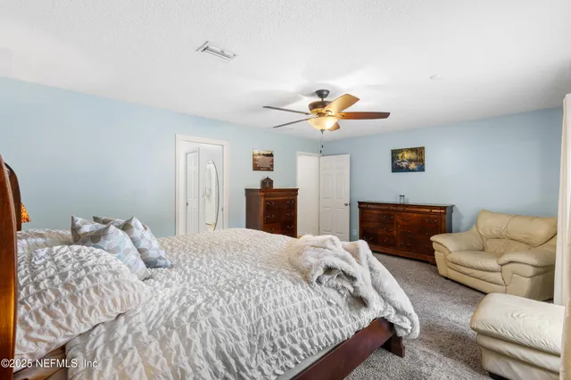 a bedroom with a bed and couch