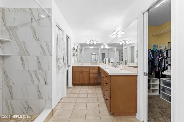 a bathroom with a sink a mirror and a shower