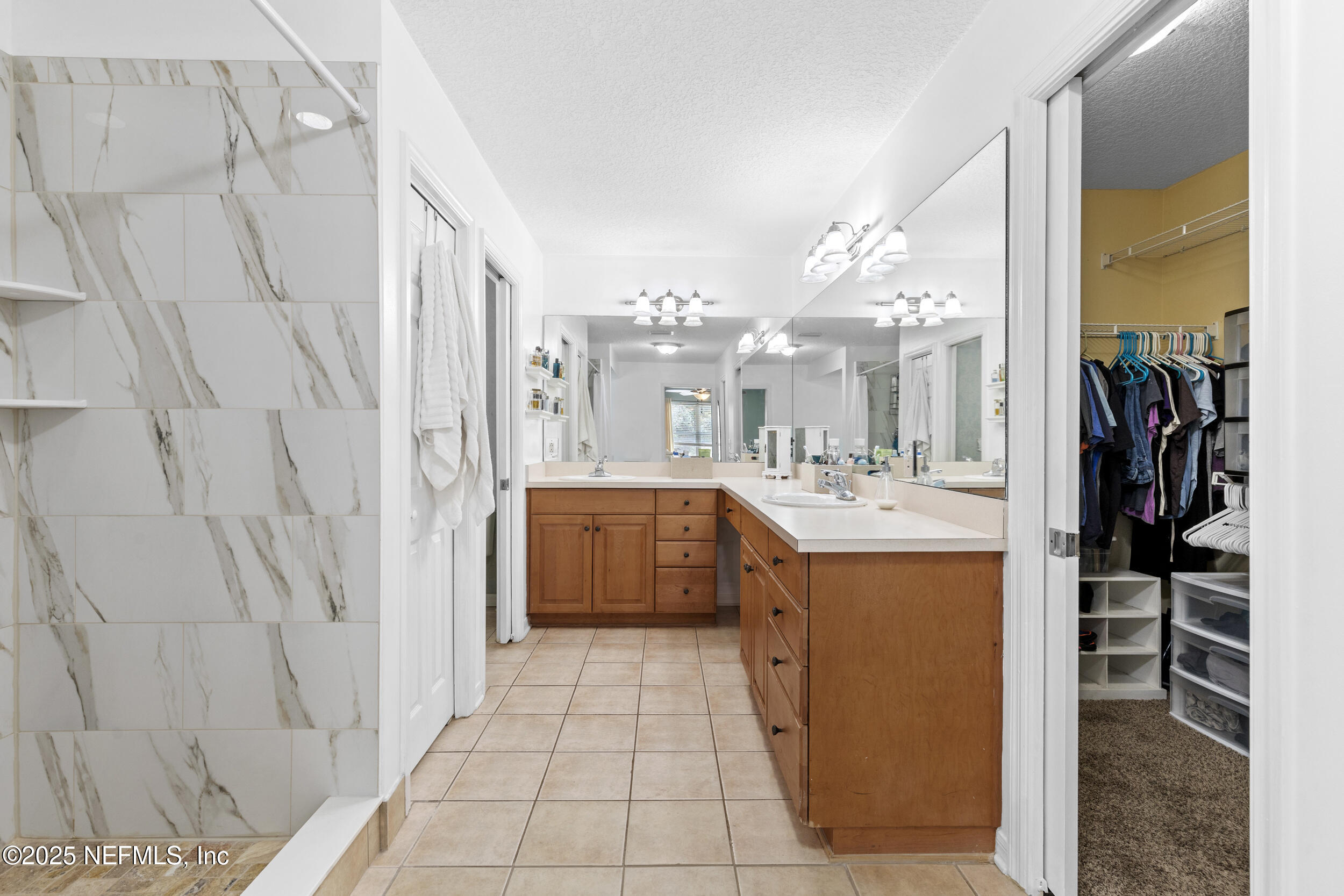 7557 Alameda Way Keystone Heights, FL 32656 - Photo 22 of 40 a bathroom with a sink a mirror and a shower