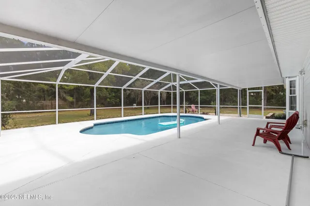 a view of a swimming pool with lounge chair