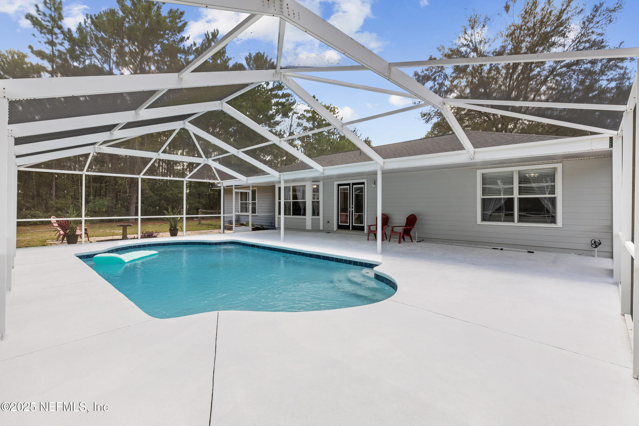 7557 Alameda Way Keystone Heights, FL 32656 - Photo 29 of 40 a view of a house with a backyard porch and sitting area