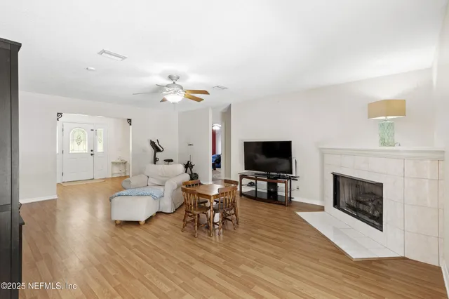 a living room with furniture fireplace and flat screen tv