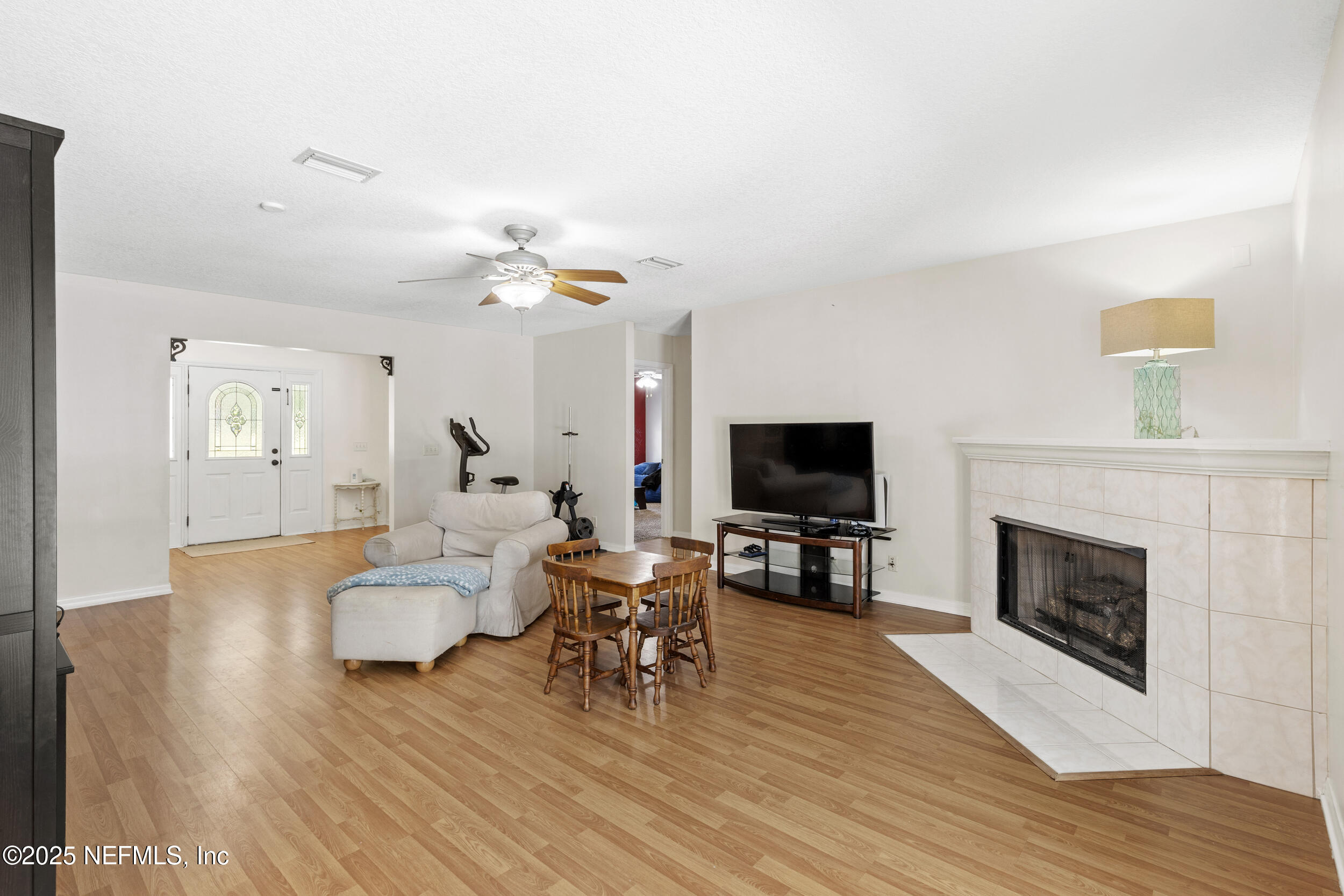 7557 Alameda Way Keystone Heights, FL 32656 - Photo 7 of 40 a living room with furniture fireplace and flat screen tv