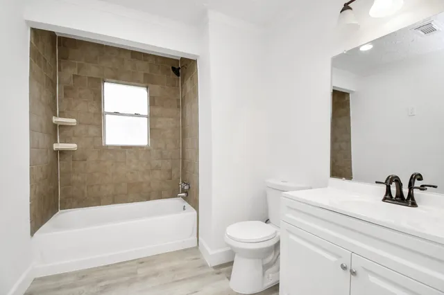 a bathroom with a toilet a sink and bathtub