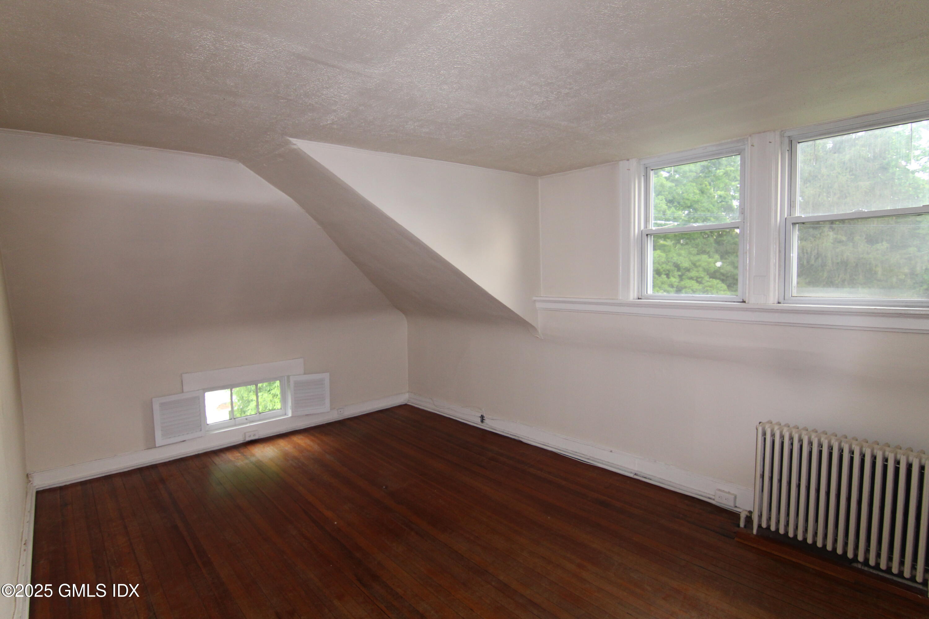 90 Riverside Avenue, Unit 5 Riverside, CT 06878 - Photo 12 of 13 a view of an empty room with wooden floor and a window