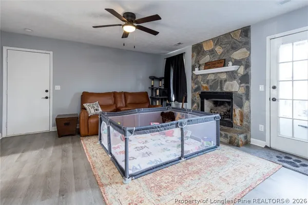a living room with furniture a air conditioner and a window