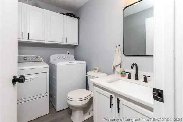 a bathroom with a sink a toilet and a mirror