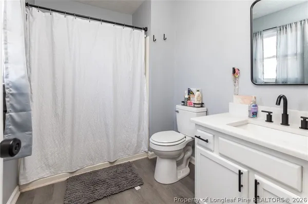 a bedroom with a bed and a ceiling fan