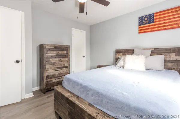 a spacious bedroom with a bed and a ceiling fan