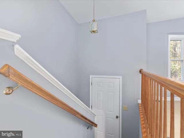 a view of a closet area with wooden floor
