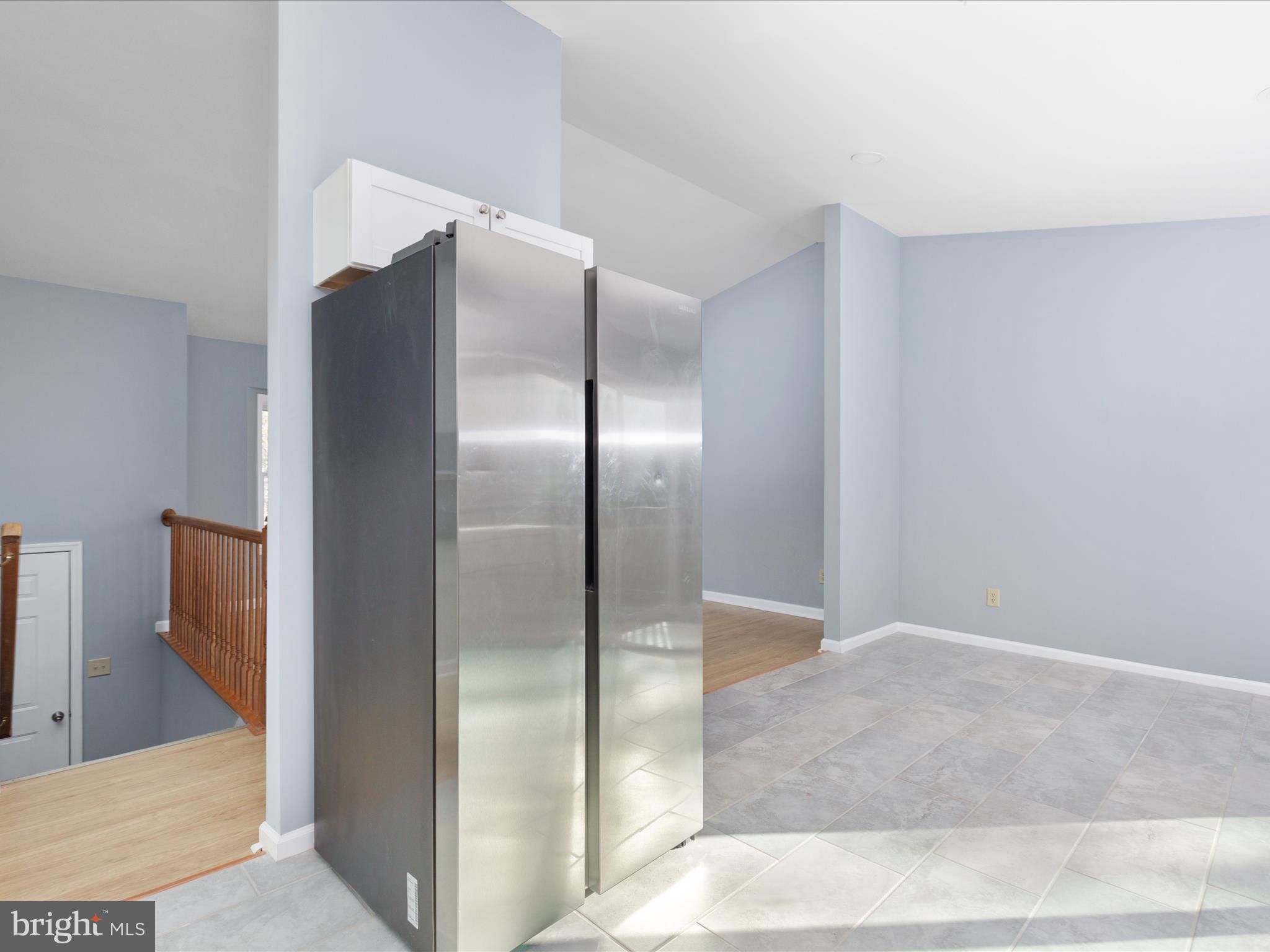 10214 Unique Trail Rixeyville, VA 22737 - Photo 12 of 48 a view of a refrigerator in kitchen and an empty room