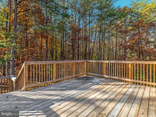 a view of backyard with deck and wooden floor