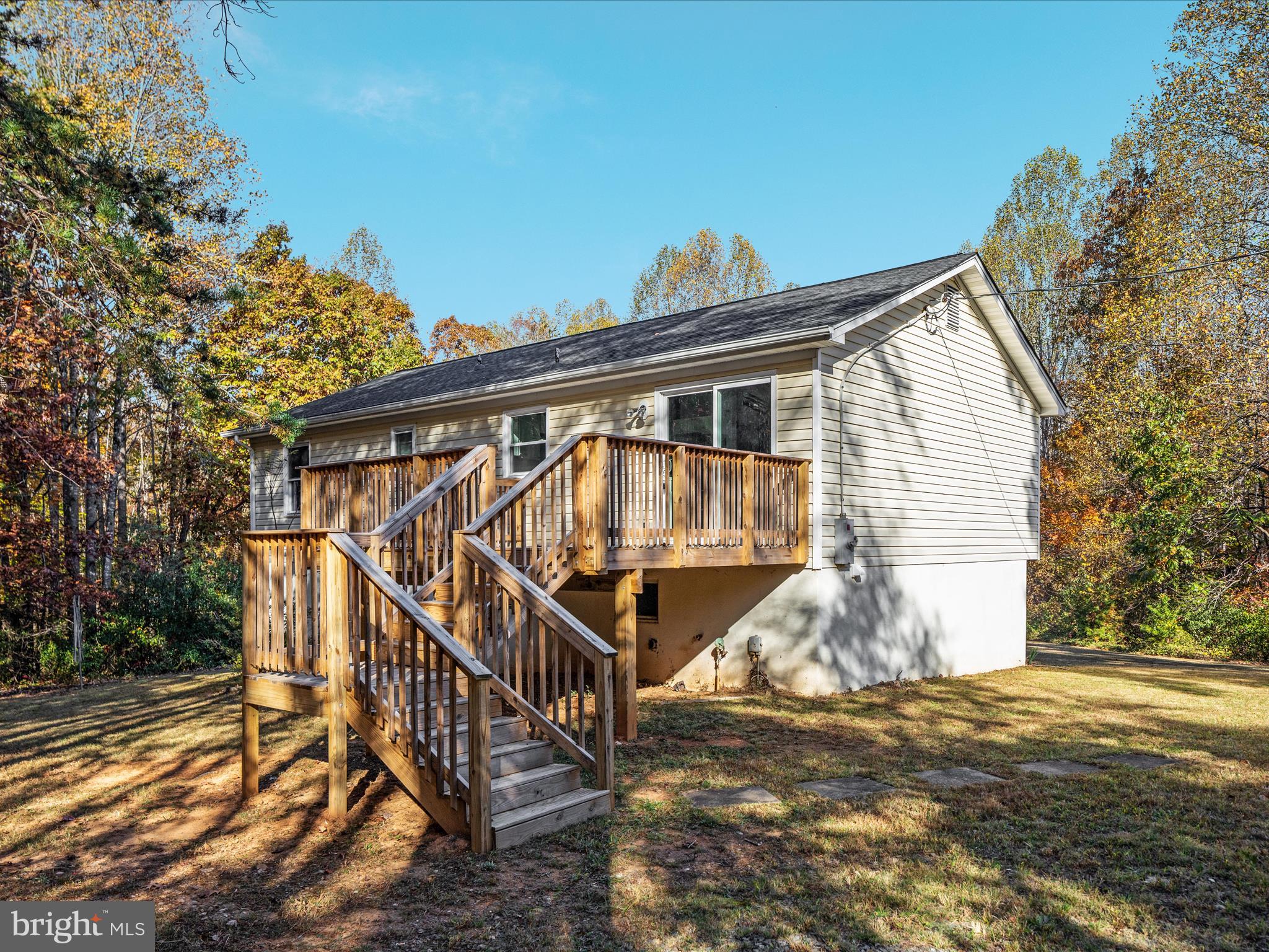 10214 Unique Trail Rixeyville, VA 22737 - Photo 47 of 48 a view of a house with wooden stairs yard and sitting area