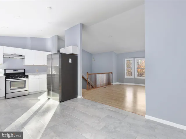 a kitchen with a refrigerator and a stove top oven