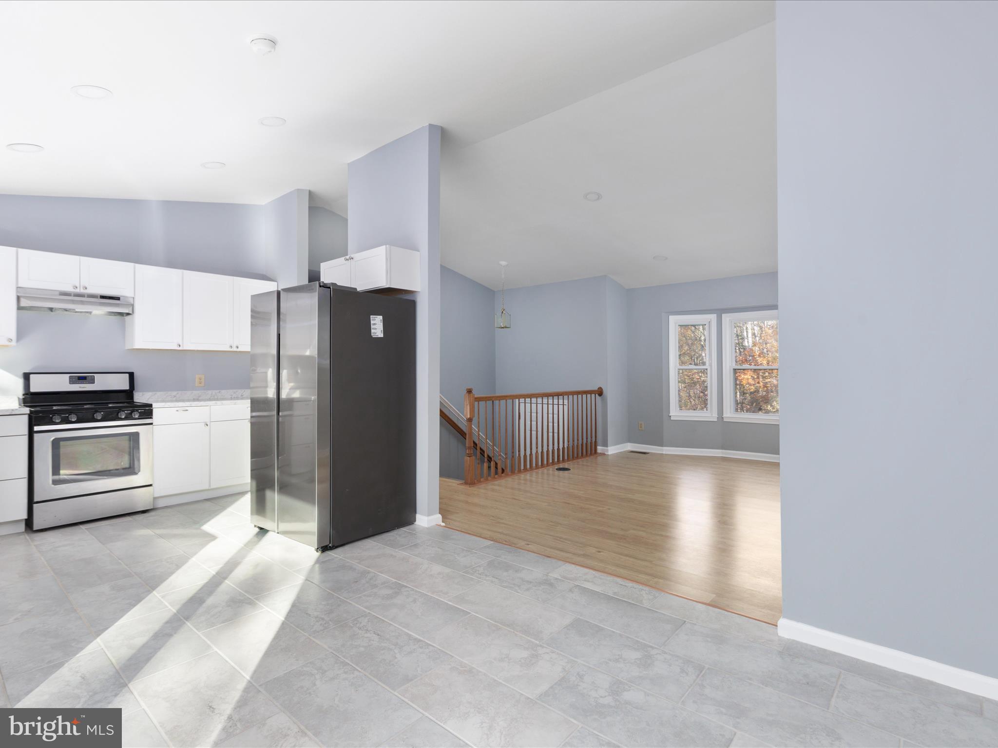 10214 Unique Trail Rixeyville, VA 22737 - Photo 6 of 48 a kitchen with a refrigerator and a stove top oven