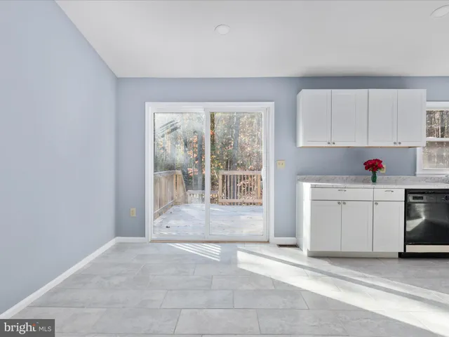a view of a kitchen with wooden floor and electronic appliances