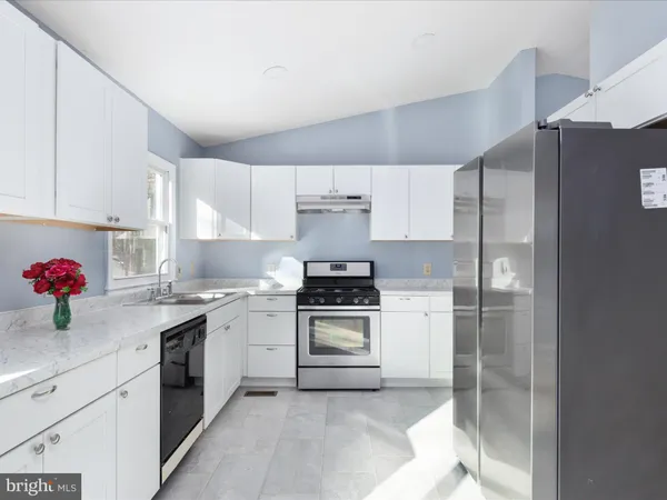 a kitchen with a stove top oven sink and cabinets