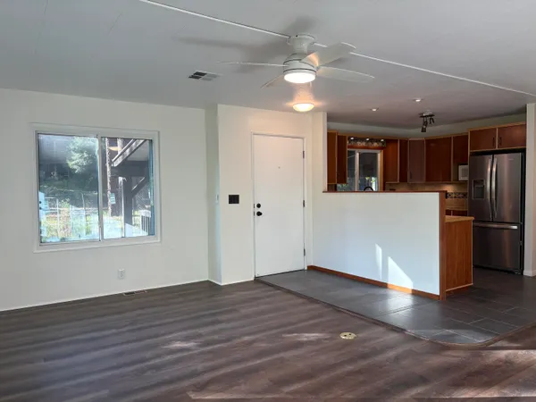 a kitchen with stainless steel appliances granite countertop a refrigerator and a sink