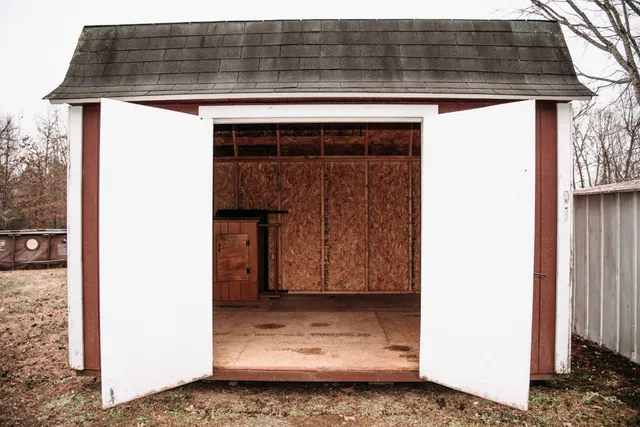a view of an empty room with closet and a window