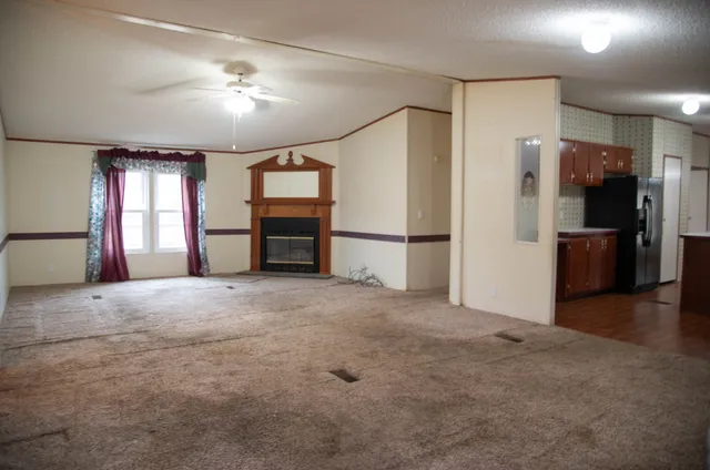 a view of a big room with a kitchen