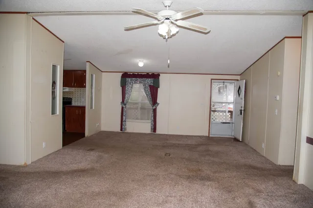 a kitchen with stainless steel appliances granite countertop a refrigerator a stove a sink and dishwasher with wooden floor