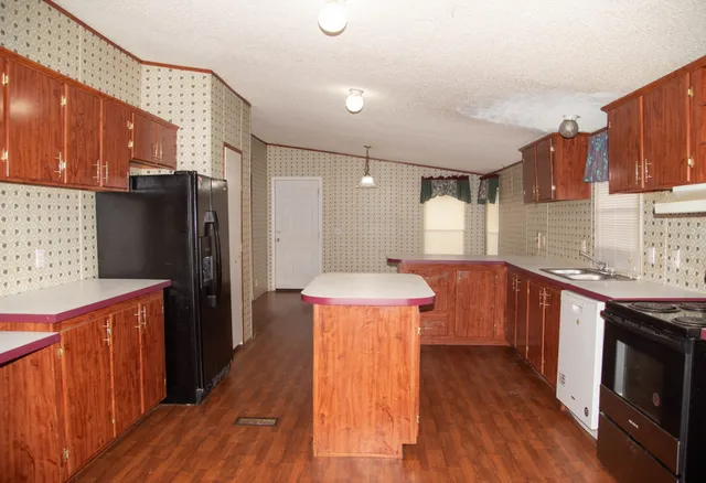 a view of a livingroom with a ceiling fan and window