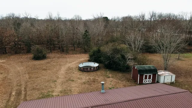 a view of a chairs and table in the backyard