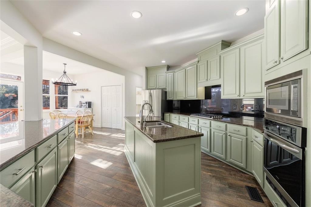 6010 Masters Club Drive Suwanee, GA 30024 - Photo 20 of 82 a kitchen with stainless steel appliances granite countertop a sink stove and refrigerator